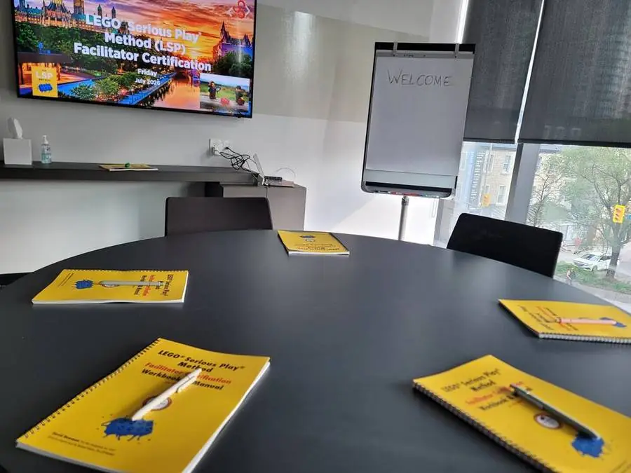 Workbooks and LEGO materials set out on the table at the start of the July Ottawa cohort